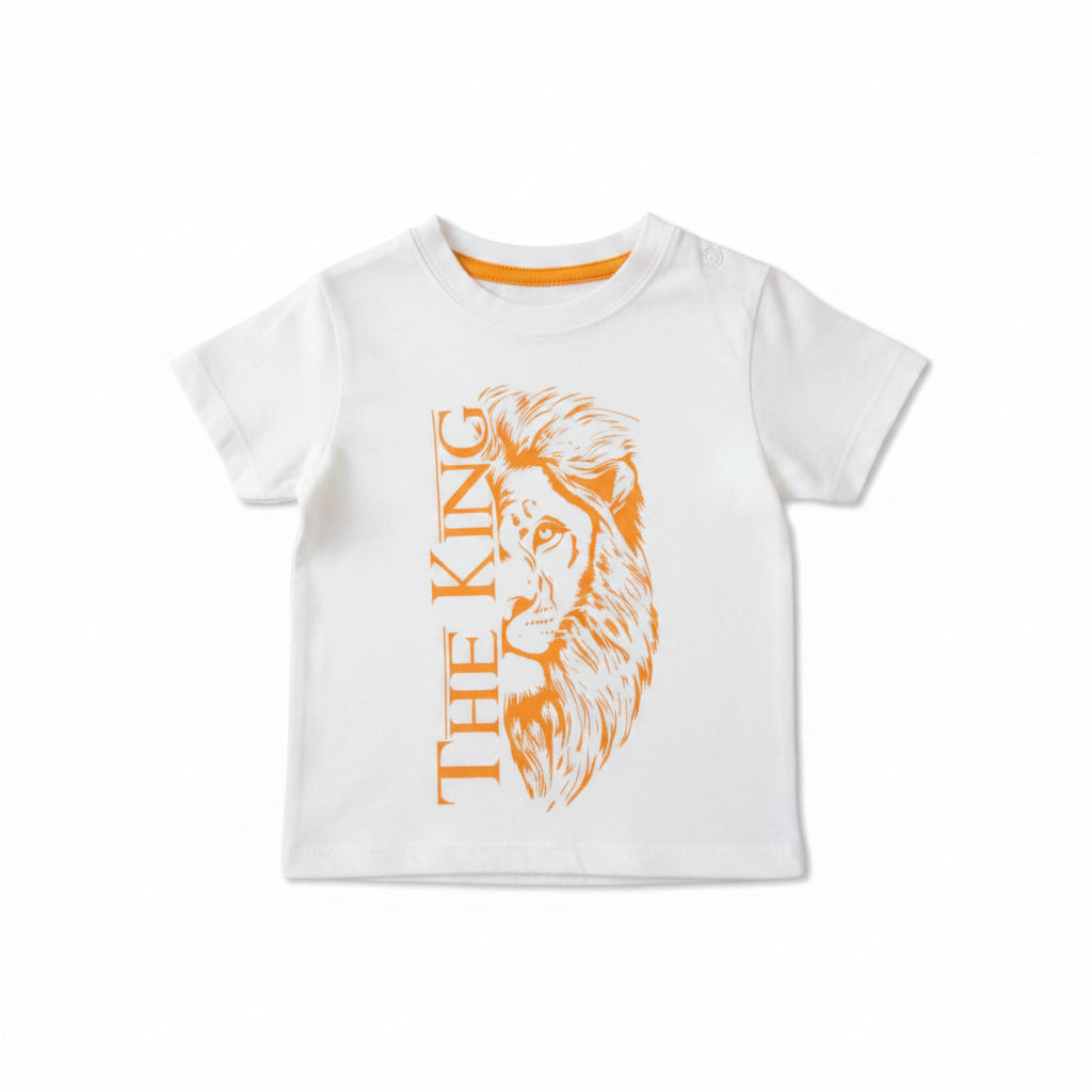 A light gray heathered short-sleeve kids' t-shirt with an orange graphic of a lion face and the text 'THE KING' printed on the front, laid flat on a light wood surface.