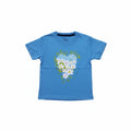 A blue short-sleeve kids' t-shirt with a heart-shaped graphic made of white and blue flowers and green leaves, laid flat on a light wood surface.